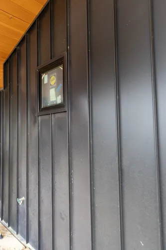Exterior Black Siding Small Window — custom home by Open Prairie (Build Process · Behind the build)