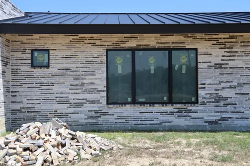 Exterior Brick Metal Roof — custom home by Open Prairie (Build Process · Behind the build)