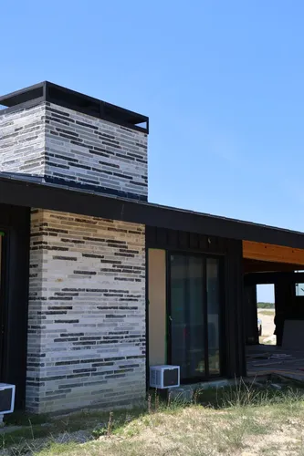 Exterior Chimney Stone Veneer — custom home by Open Prairie (Build Process · Behind the build)