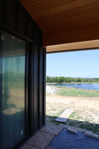 Exterior Patio Door Lake View — custom home by Open Prairie (Build Process · Behind the build)