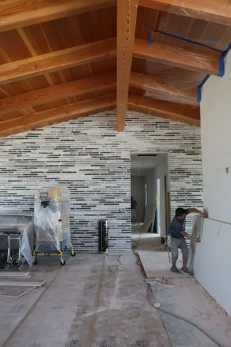 Tile Accent Wall Worker — custom home by Open Prairie (Build Process · Behind the build)