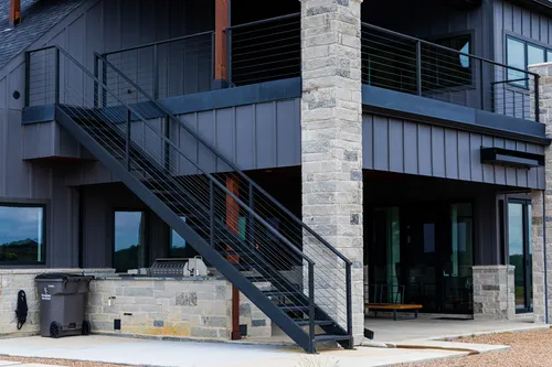Exterior Lower Staircase Outdoor Kitchen — custom home by Open Prairie (The Barndominium · Graford)