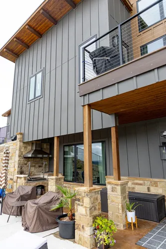 Exterior Rear Outdoor Kitchen Balcony — custom home by Open Prairie (The Estate · Graford)