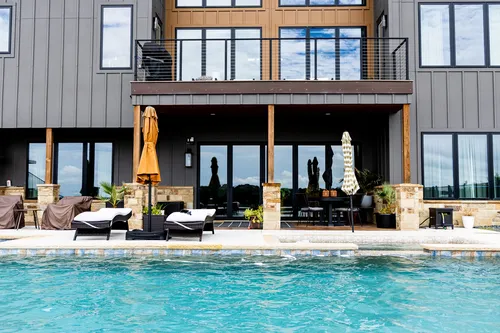 Exterior Rear Pool Lounge — custom home by Open Prairie (The Estate · Graford)