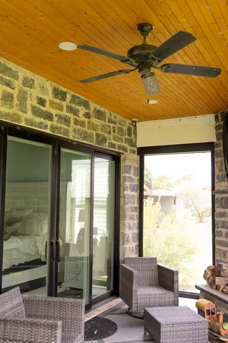 Covered Patio Wicker Seating — custom home by Open Prairie (The Lakehouse · Graford)