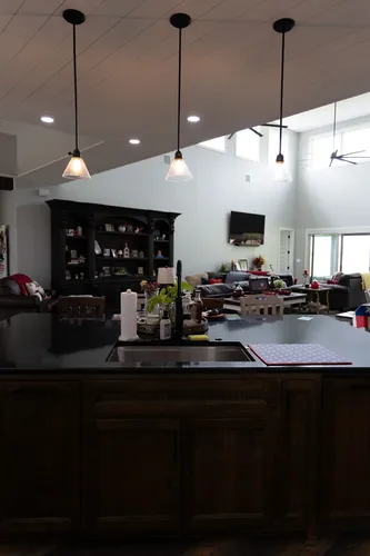 Kitchen Island Sink Living View — custom home by Open Prairie (The Lakehouse · Graford)