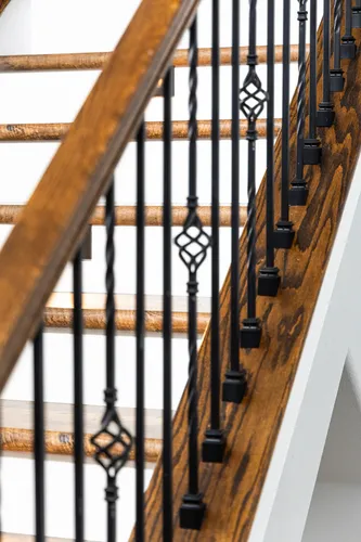 Staircase Iron Balusters Closeup — custom home by Open Prairie (The Lakehouse · Graford)