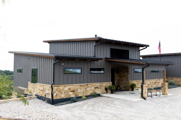Estate-scale custom home with stone exterior and wide driveway built by Open Prairie in North Texas